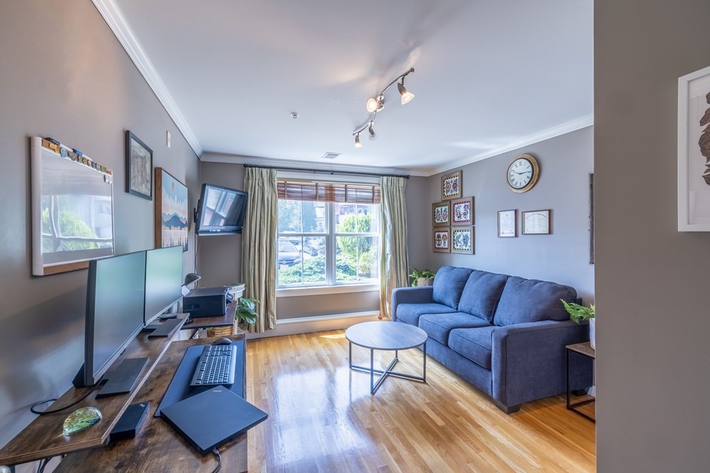 75 Main Street, Unit 102 Amesbury, MA 01913 - Photo 19 of 28 a living room with furniture and a window