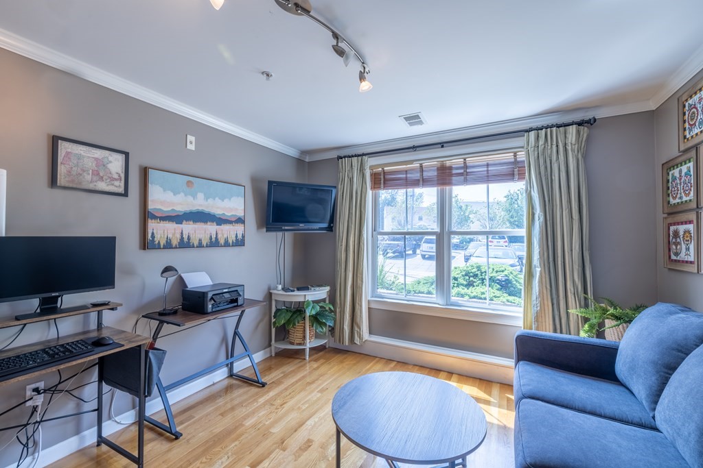 75 Main Street, Unit 102 Amesbury, MA 01913 - Photo 20 of 28 a living room with furniture and a flat screen tv