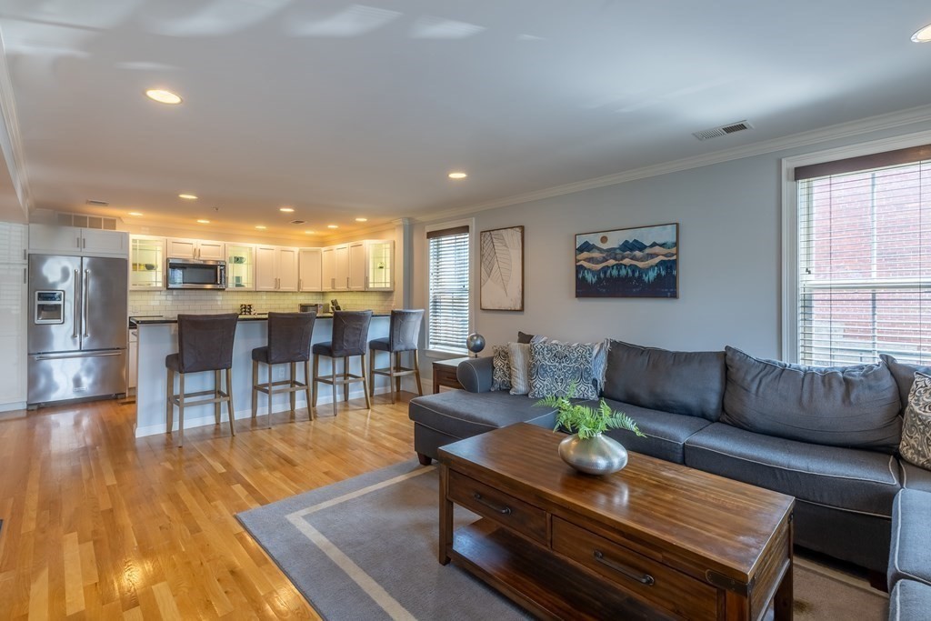 75 Main Street, Unit 102 Amesbury, MA 01913 - Photo 2 of 28 a living room with furniture and wooden floor
