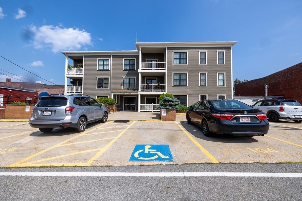 75 Main Street, Unit 102 Amesbury, MA 01913 - Photo 21 of 28 a view of car parked in front of a building