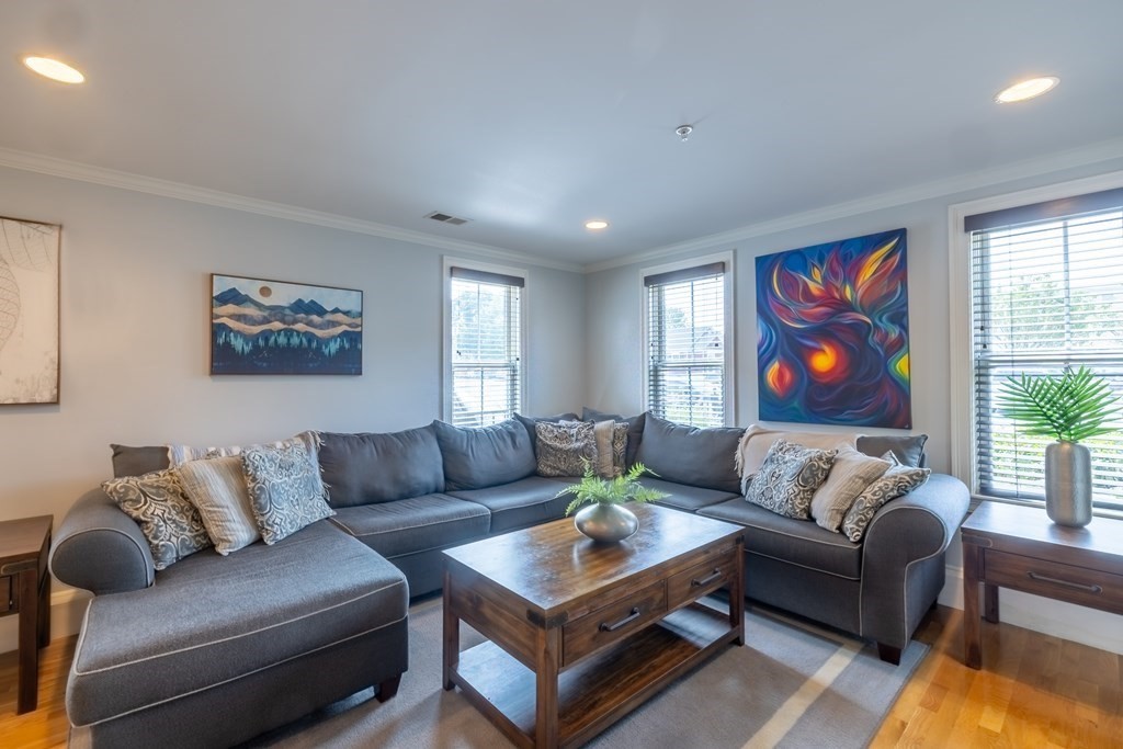 75 Main Street, Unit 102 Amesbury, MA 01913 - Photo 7 of 28 a living room with furniture potted plant and a window