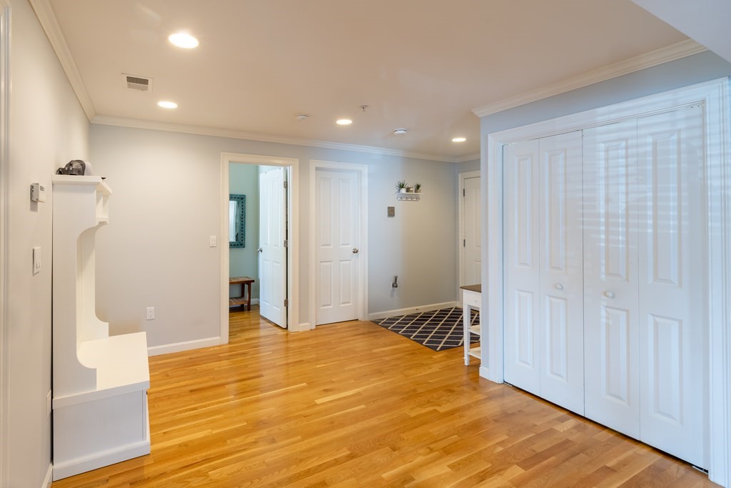 75 Main Street, Unit 102 Amesbury, MA 01913 - Photo 10 of 28 a view of a livingroom with wooden floor and bathroom