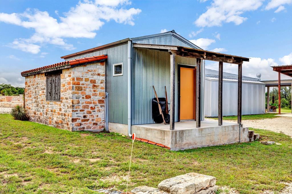 4273 Morris Ranch Road Fredericksburg, TX 78624 - Photo 14 of 24 Stone and metal barn with sliding doors.