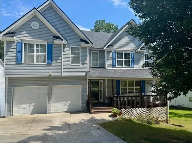 a front view of a house with a yard and garage