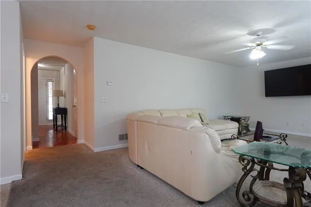 a hallway with white walls and door