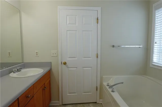 a bathroom with a sink a toilet and a window