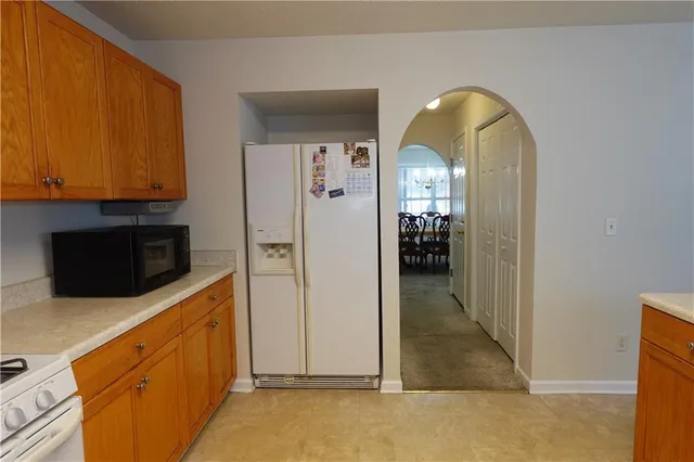 a kitchen with stainless steel appliances white cabinets and a refrigerator