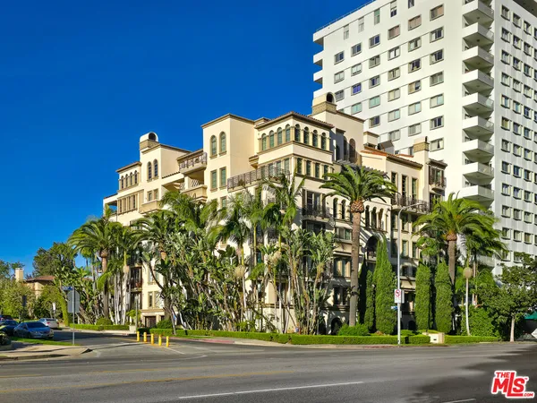 a view of a tall building next to a road