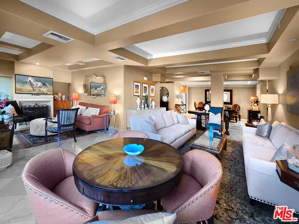 a living room with furniture and a dining table