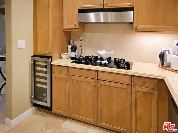 a kitchen with stainless steel appliances a stove and cabinets