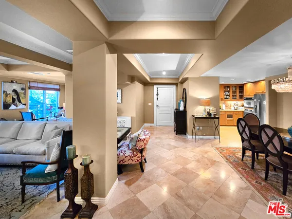 a living room with furniture and kitchen view