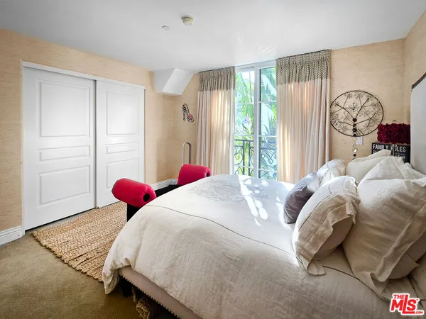 a bedroom with a bed and a closet