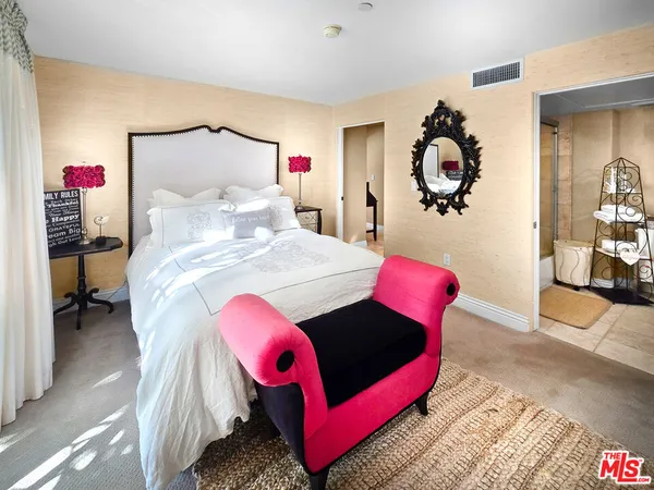 a bedroom with a bed and a table in it