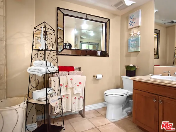 a bathroom with a sink toilet and mirror