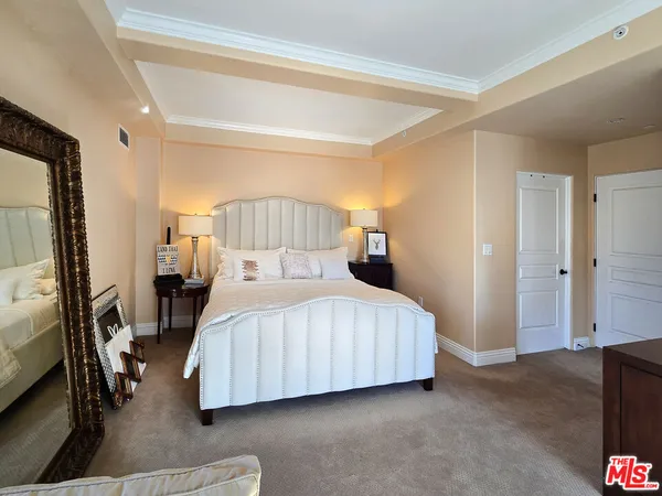 a bedroom with a bed and a mirror