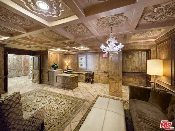 a lobby with furniture and a chandelier