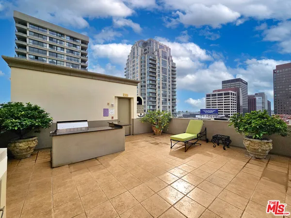 a swimming pool with outdoor seating and barbeque oven