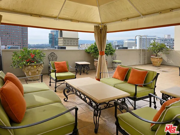 a view of a patio with table and chairs and potted plants