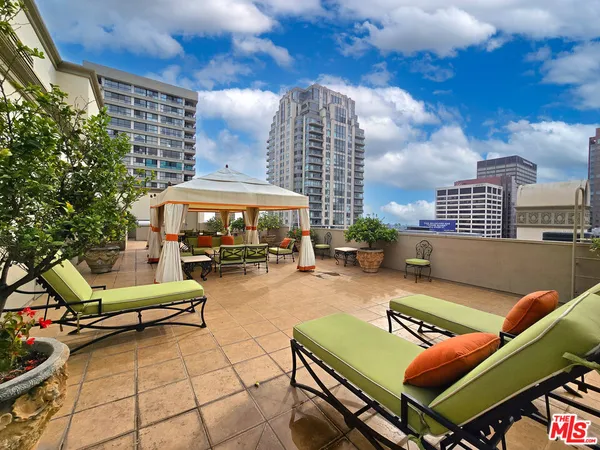a backyard of a house with barbeque oven table and chairs