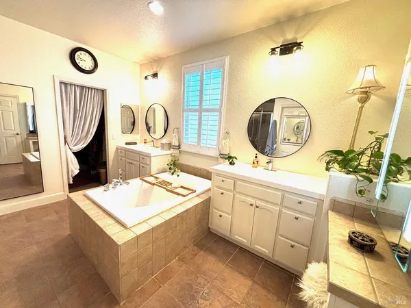 a bathroom with a sink double vanity and a mirror