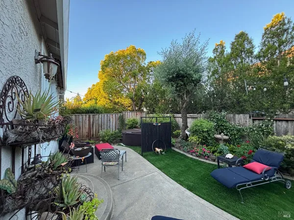 a backyard of a house with lots of green space and plants