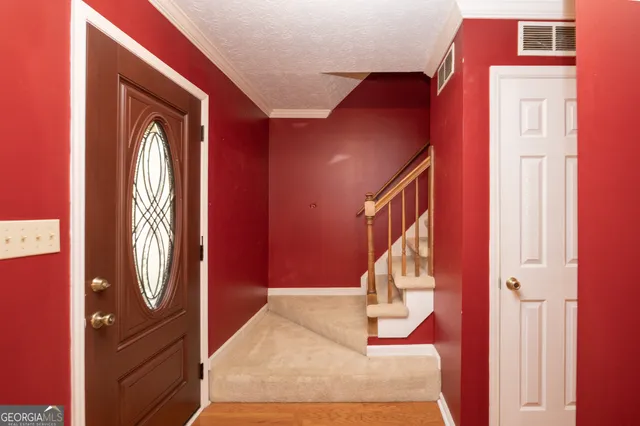 a view of a red door and a window