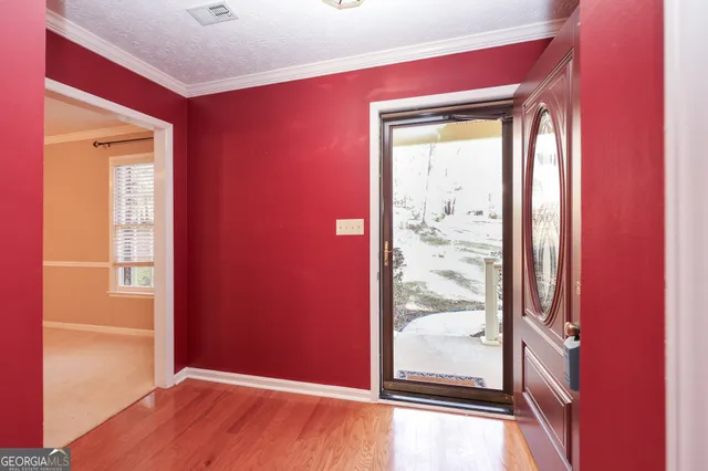 a view of an empty room with a fireplace and a window