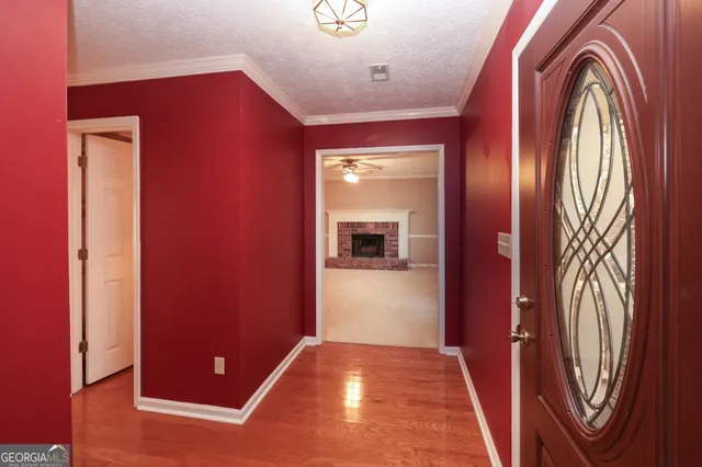 a view of an empty room with chandelier fan