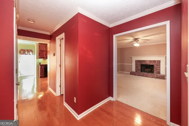 an empty room with windows and fireplace
