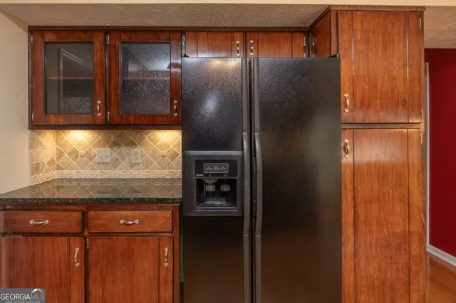 a view of a room with a window and wooden floor