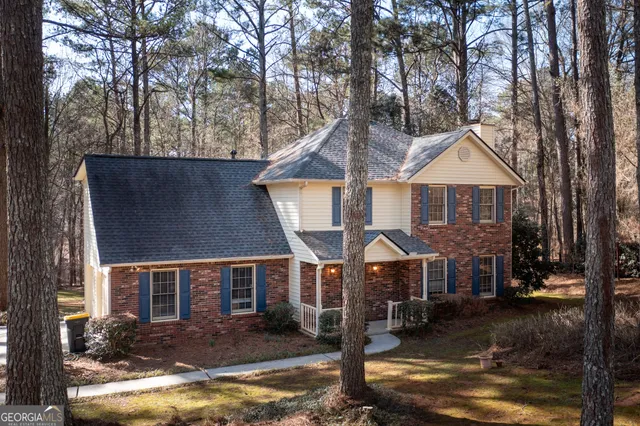a front view of a house with a yard balcony