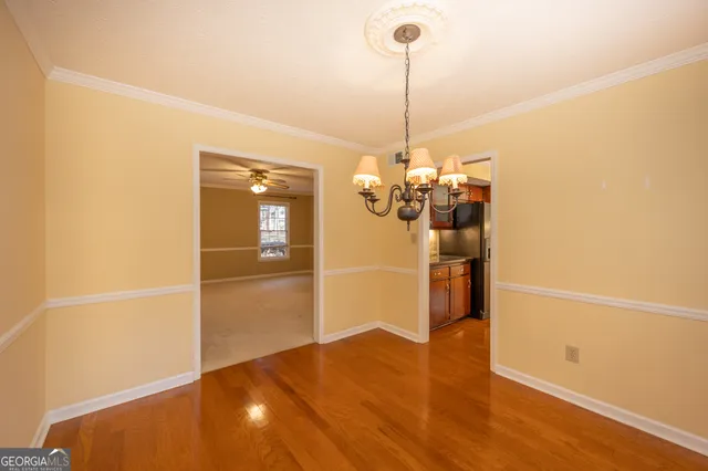 a view of a room with a window and a ceiling fan