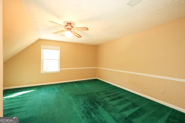 a bathroom with a granite countertop sink a toilet and a mirror