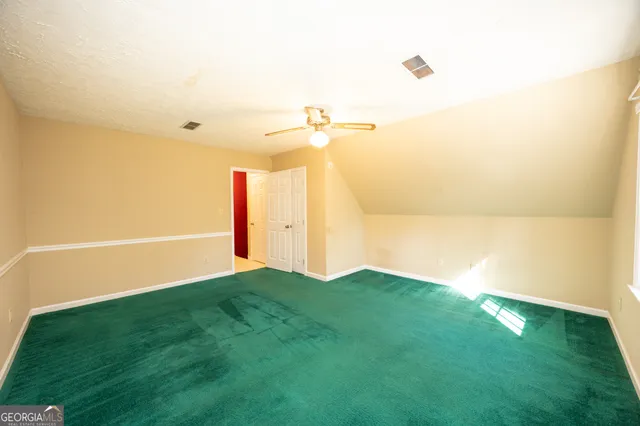 a kitchen with white cabinets and window