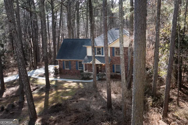 a backyard of a house with table and chairs