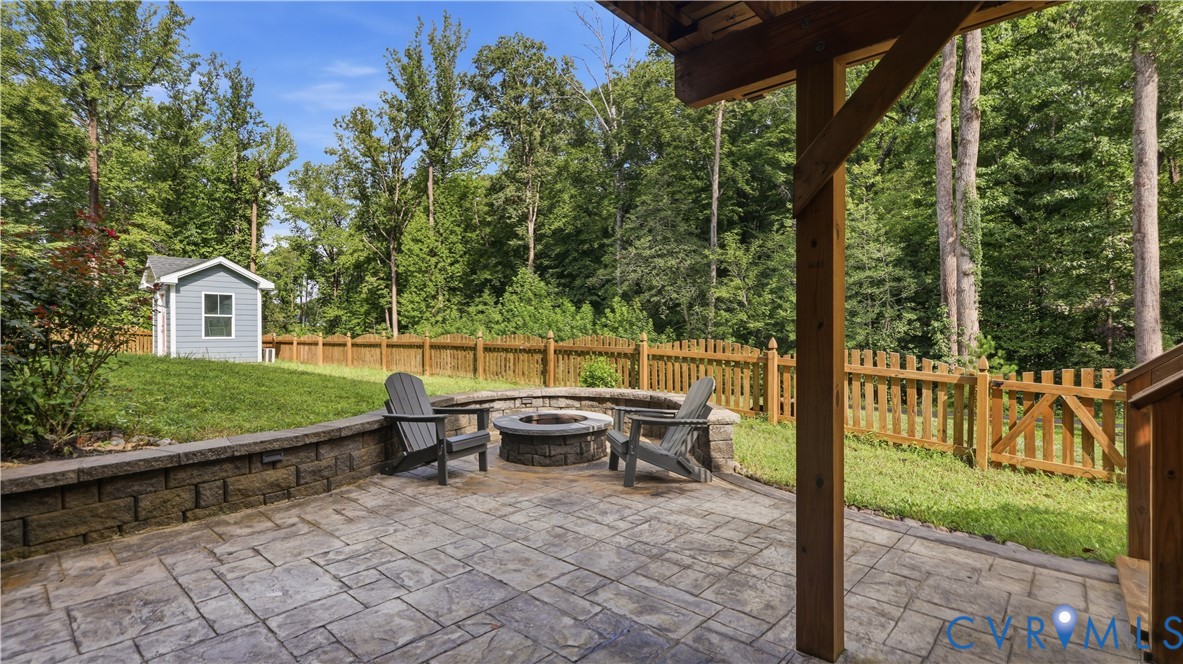 9308 Rudders Point Cove Mechanicsville, VA 23116 - Photo 37 of 50 Stamped concrete patio with a built-in stone fire