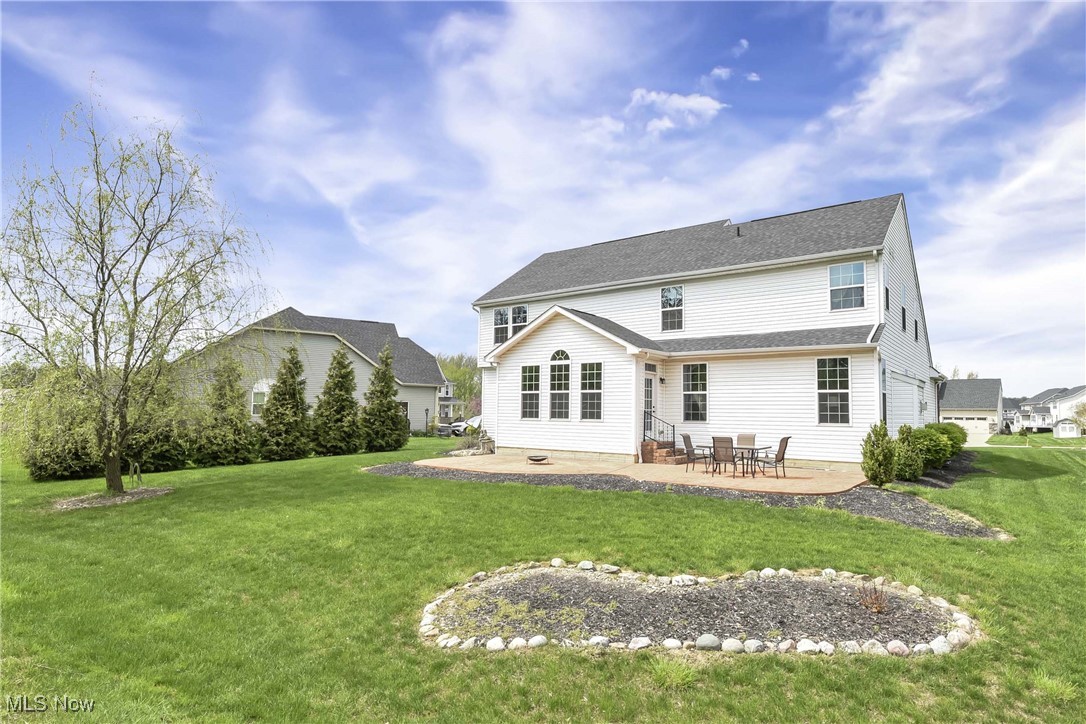 4614 Ridgestone Way Medina, OH 44256 - Photo 22 of 32 Back of property with a yard, a patio, and entry steps