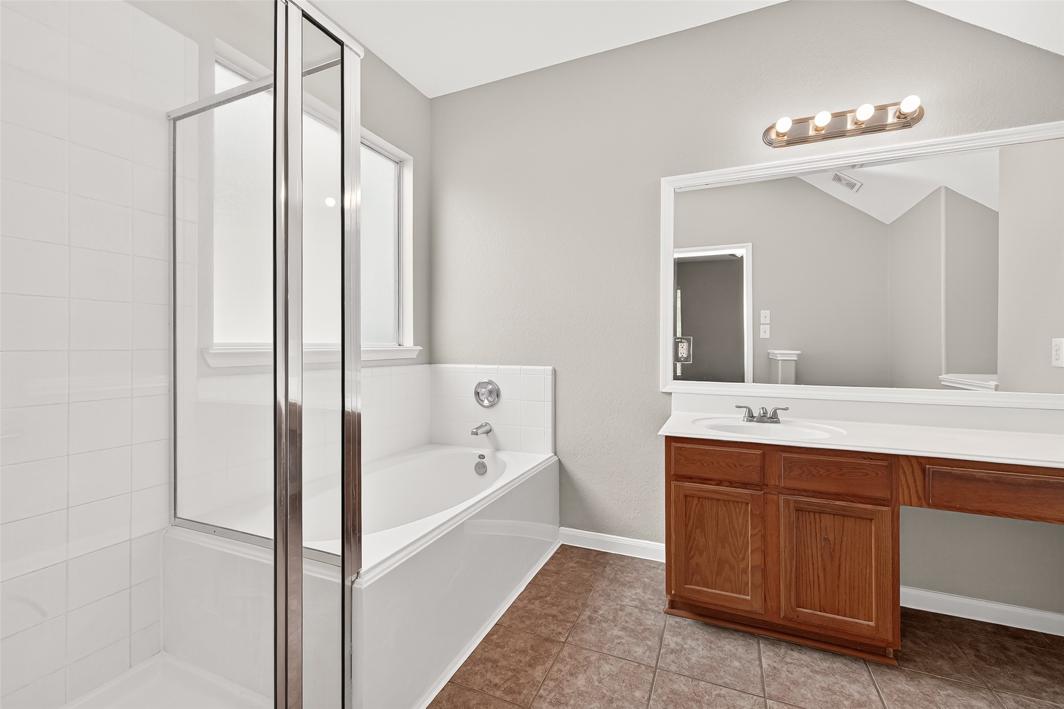 21327 Bella Flora Court Spring, TX 77379 - Photo 23 of 50 a bathroom with a tub sink and mirror