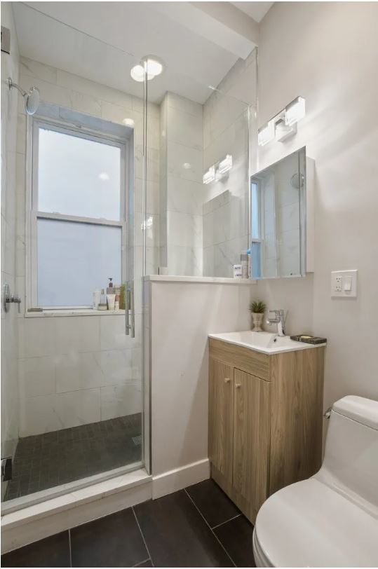 2153 West Potomac Avenue, Unit 2F Chicago, IL 60622 - Photo 12 of 15 a bathroom with a sink a toilet and shower