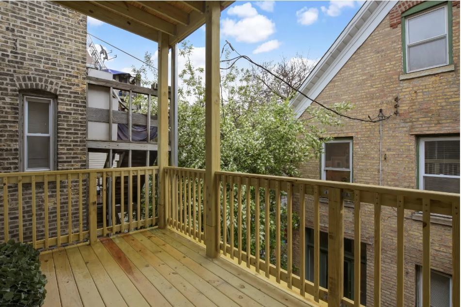 2153 West Potomac Avenue, Unit 2F Chicago, IL 60622 - Photo 14 of 15 a view of a brick house with large windows