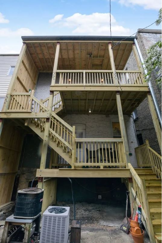 2153 West Potomac Avenue, Unit 2F Chicago, IL 60622 - Photo 15 of 15 a view of roof deck with wooden floor and fence