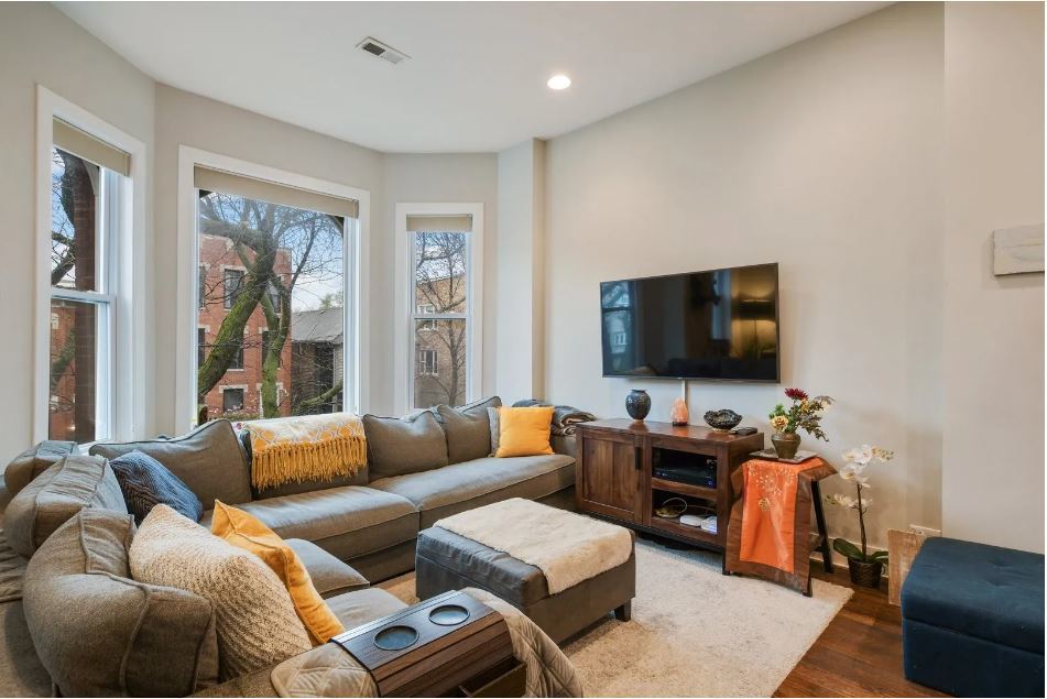 2153 West Potomac Avenue, Unit 2F Chicago, IL 60622 - Photo 2 of 15 a living room with furniture and a flat screen tv