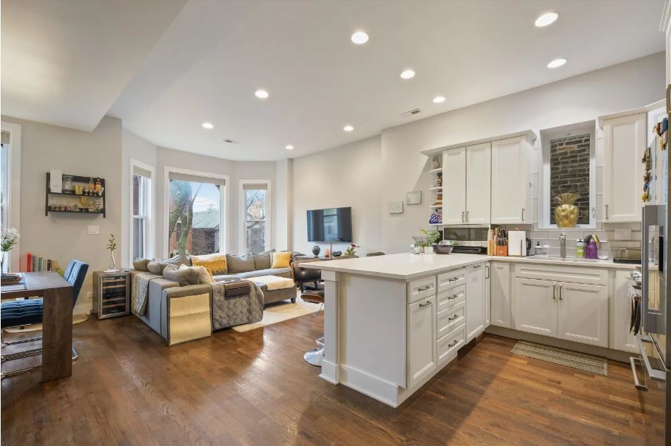 2153 West Potomac Avenue, Unit 2F Chicago, IL 60622 - Photo 3 of 15 a large white kitchen with a large window and white cabinets