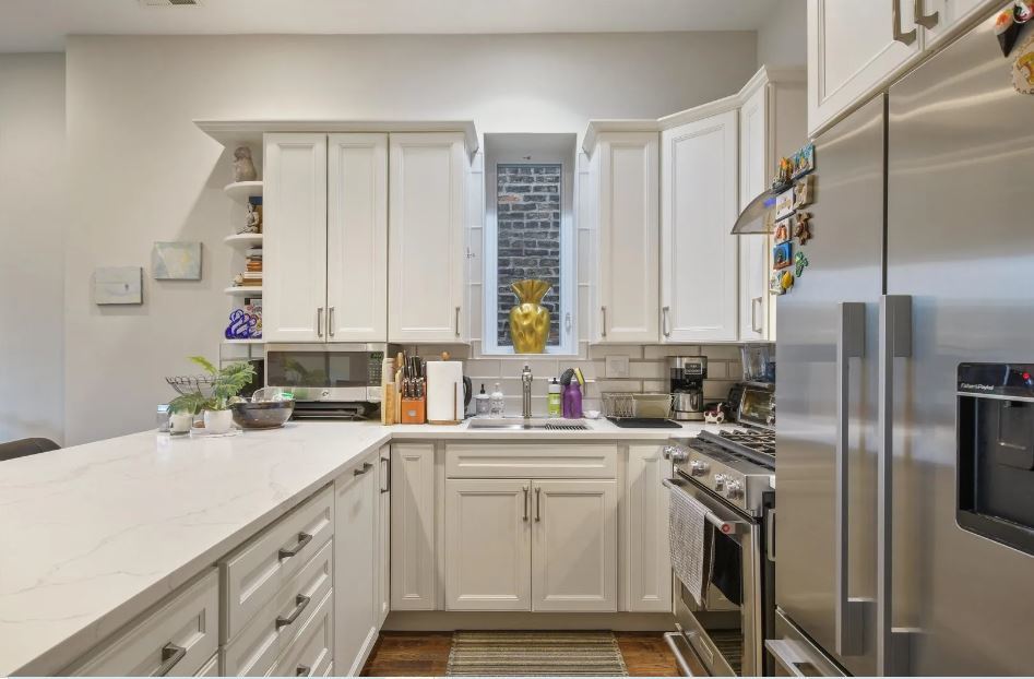 2153 West Potomac Avenue, Unit 2F Chicago, IL 60622 - Photo 4 of 15 a kitchen with a sink cabinets and stainless steel appliances