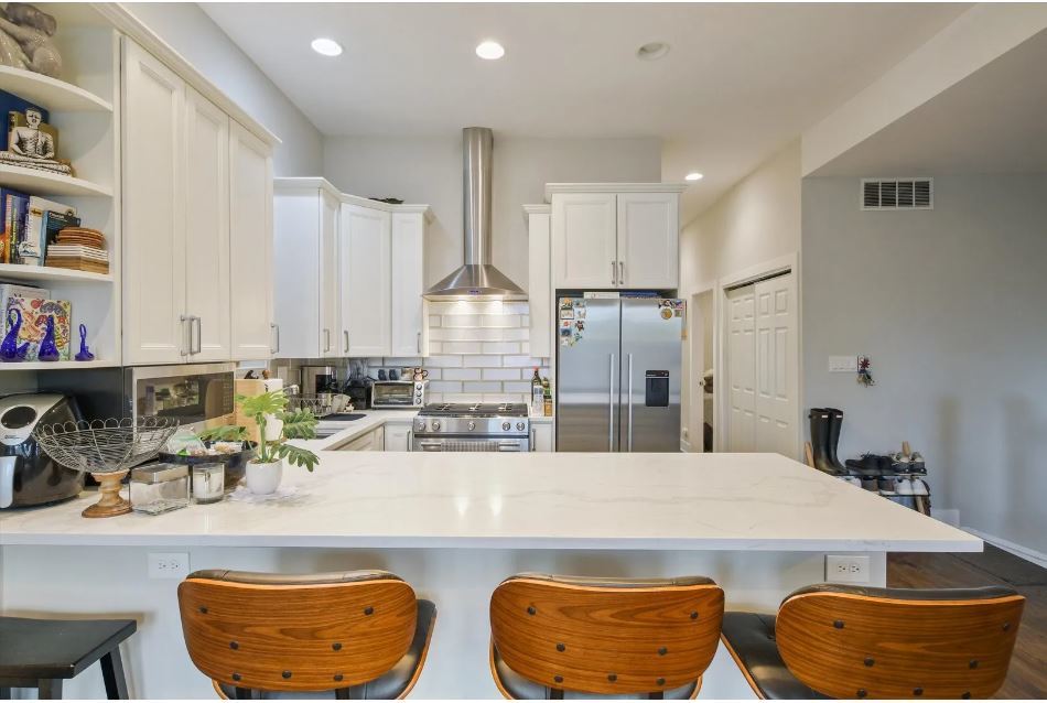 2153 West Potomac Avenue, Unit 2F Chicago, IL 60622 - Photo 5 of 15 a kitchen with stainless steel appliances granite countertop a sink a stove a refrigerator and cabinets