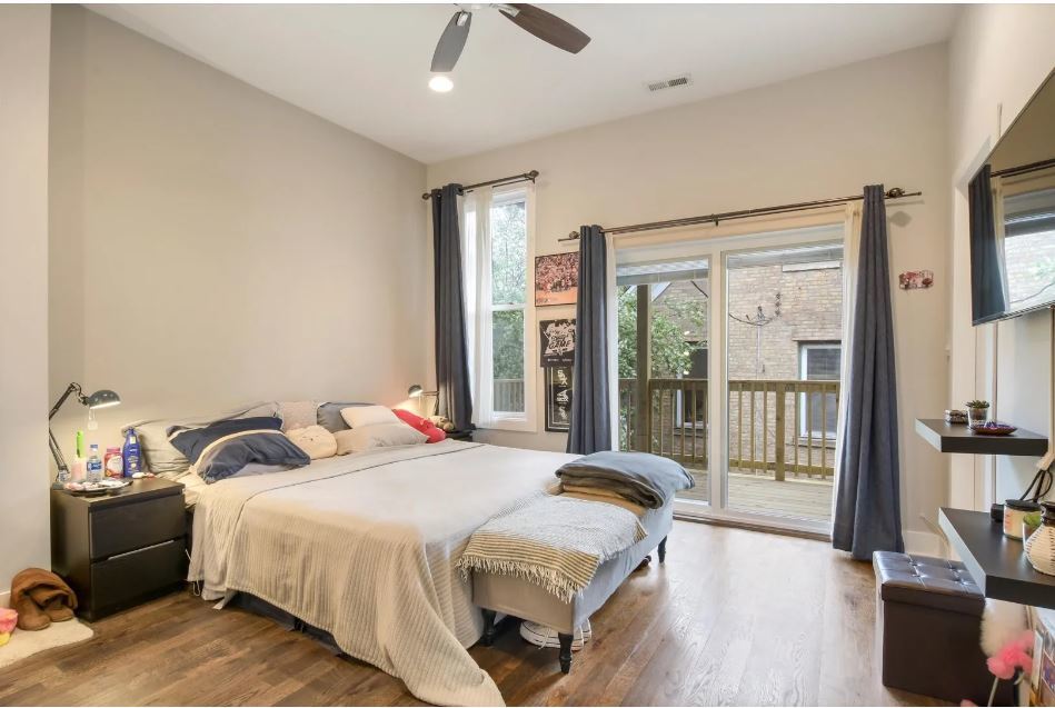 2153 West Potomac Avenue, Unit 2F Chicago, IL 60622 - Photo 7 of 15 a bedroom with a bed and a large window