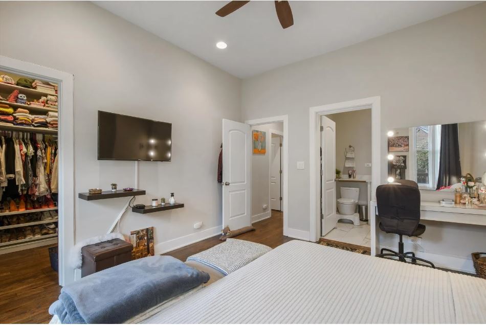 2153 West Potomac Avenue, Unit 2F Chicago, IL 60622 - Photo 9 of 15 a bedroom with furniture and a flat screen tv