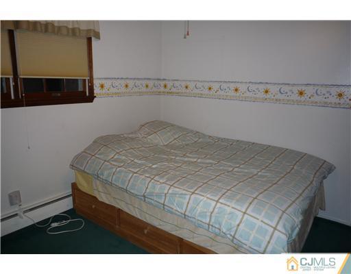 21 Eastlick Road Edison, NJ 08817 - Photo 7 of 8 a bedroom with a bed and a night stand