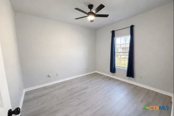 wooden floor in an empty room with a window