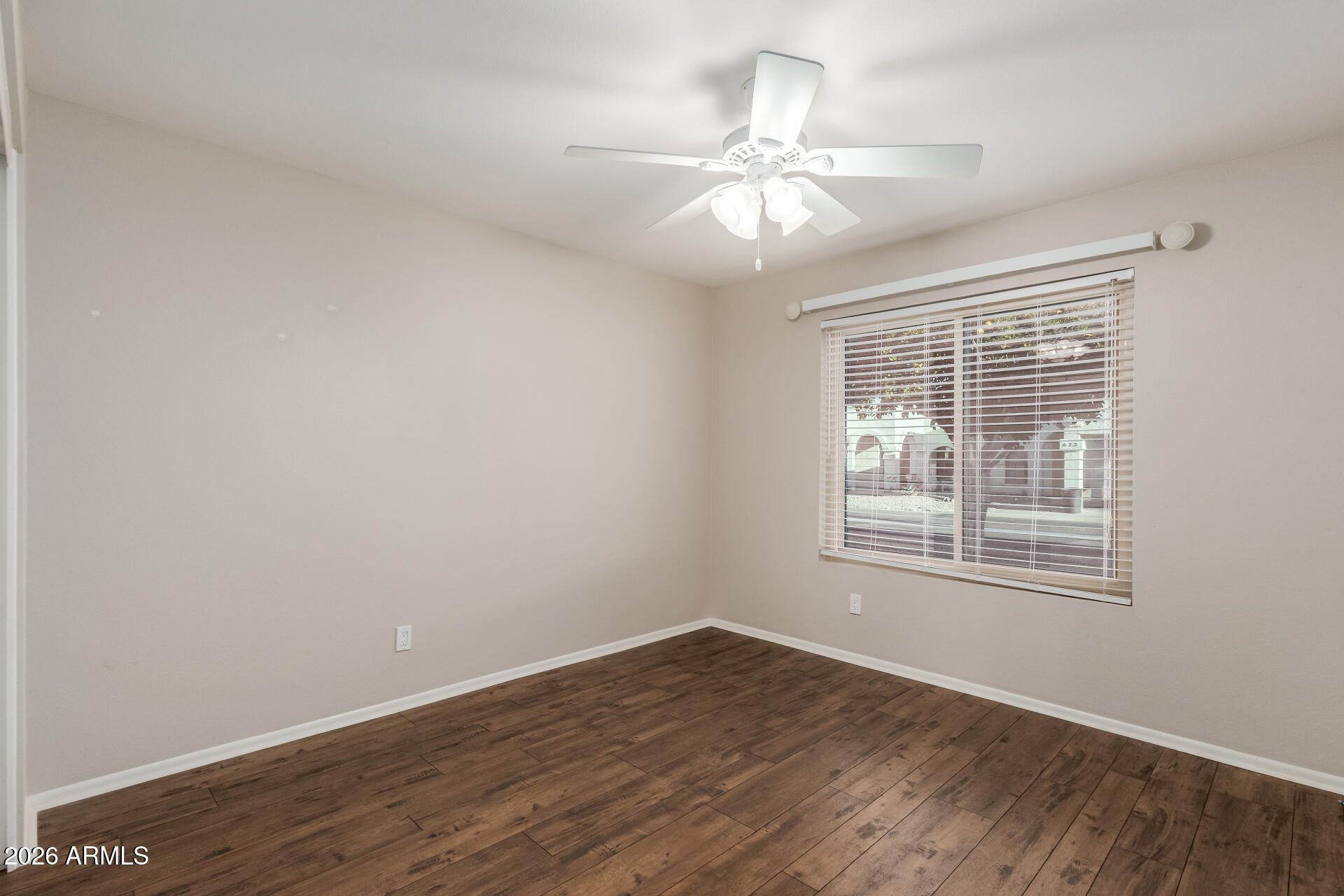 632 South 79th Way Mesa, AZ 85208 - Photo 17 of 30 an empty room with wooden floor fan and windows